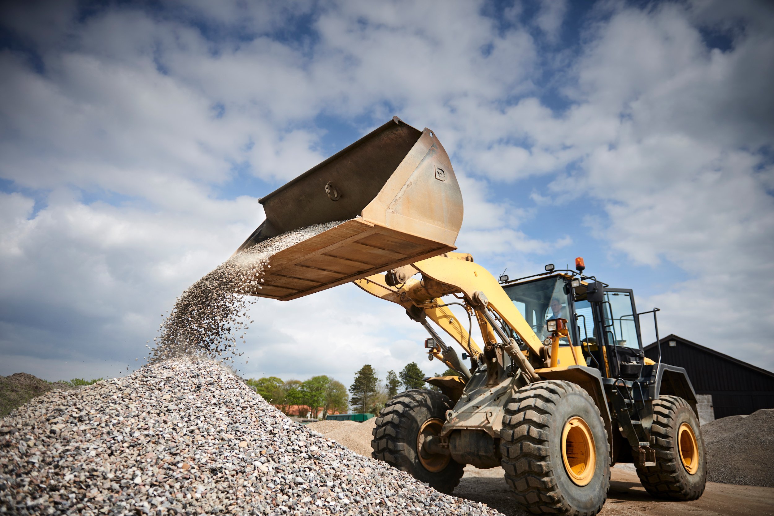 Excavator moving sand